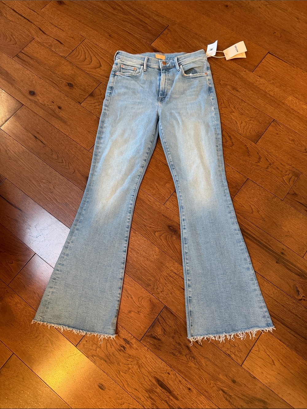 MOTHER Light Blue High-Rise Flared Jeans with Raw Fringe Hem